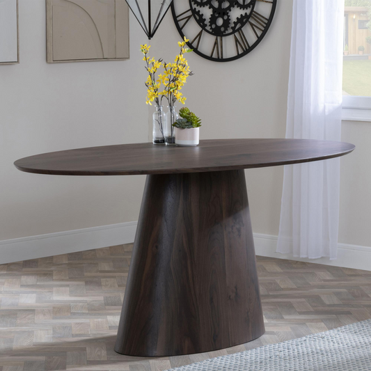 Wooden dining table with decorative items in a room setting