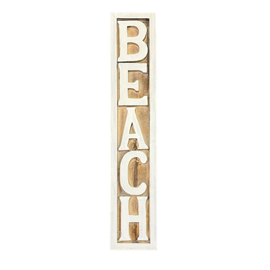A wooden sign, vertically oriented reading "beach", with a natural wood surface and the text in white capital letters. Coastal decor style.