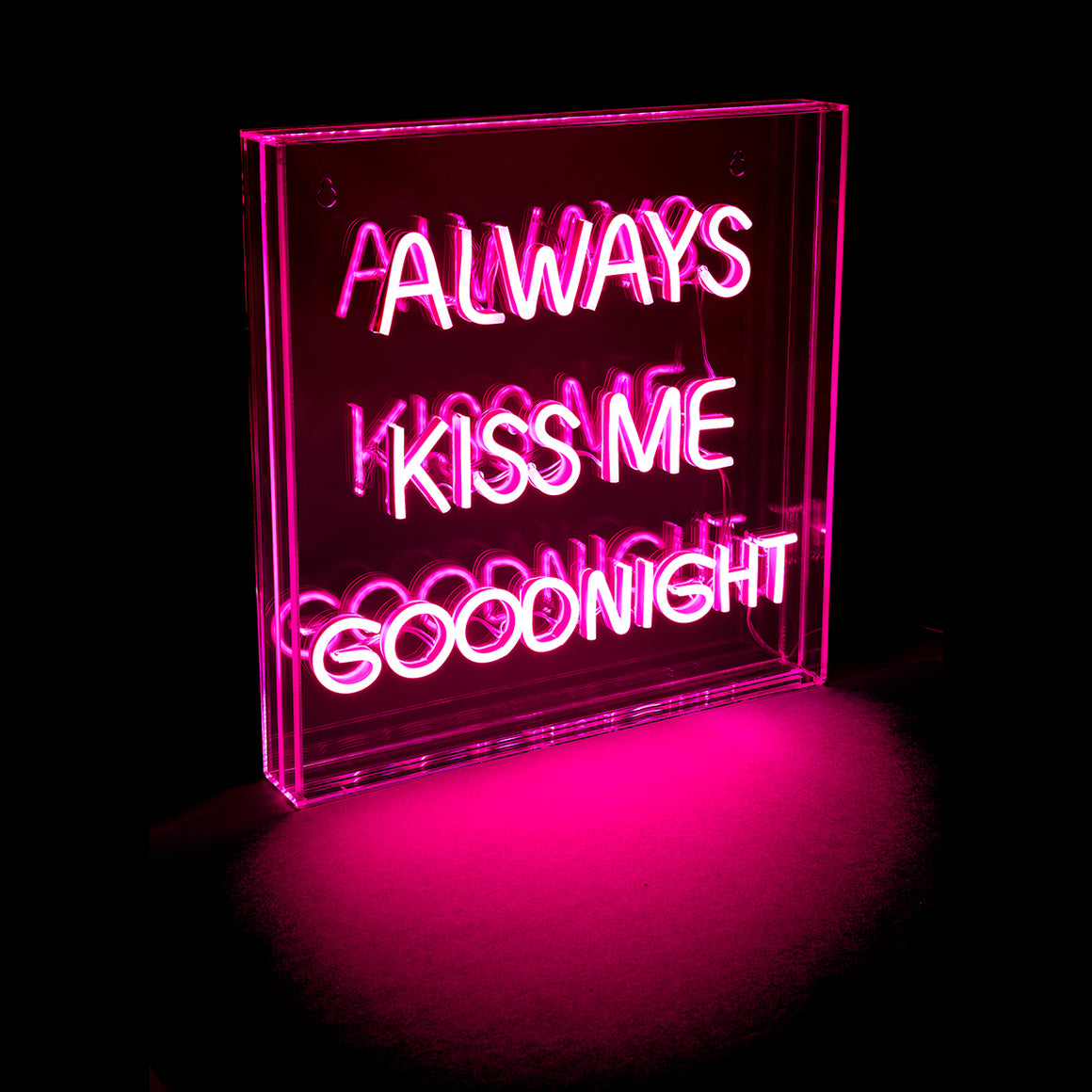 Neon sign with the text 'Always Kiss Me Goodnight' on a black background