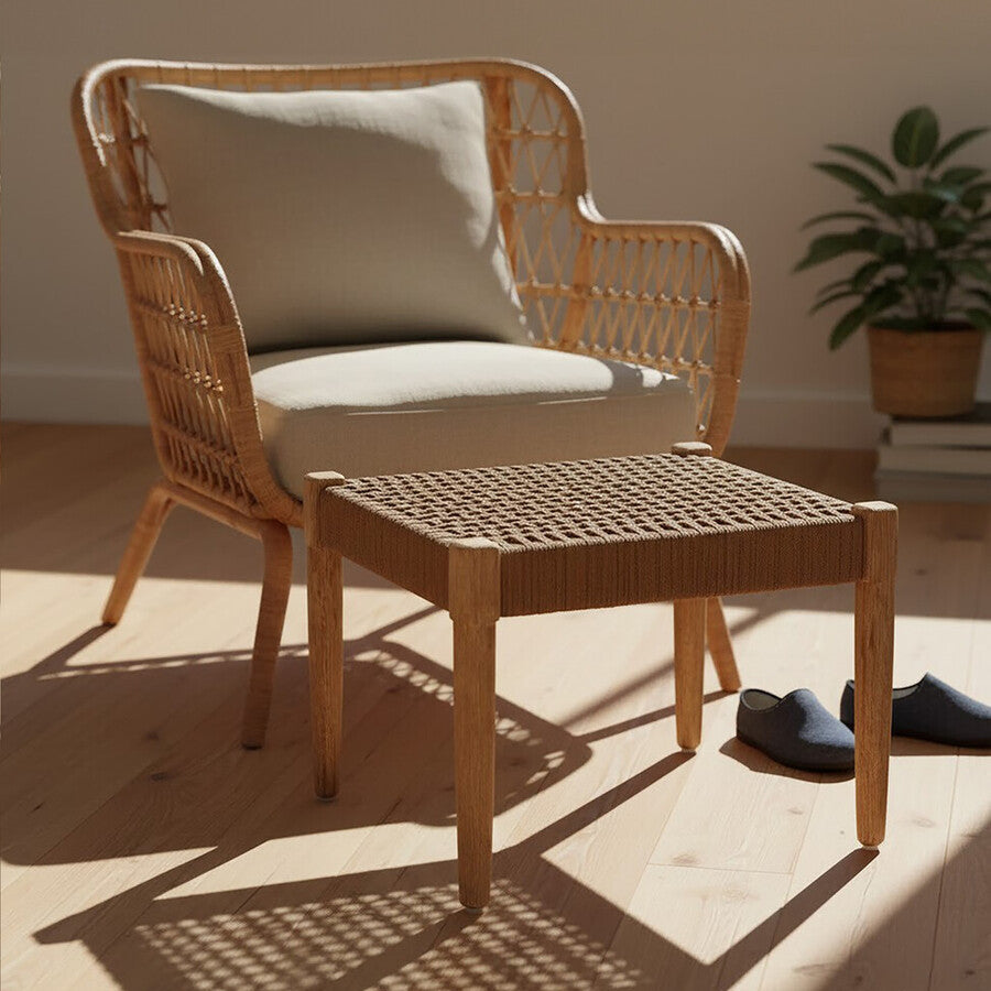 Wicker chair with beige cushion on a wooden floor