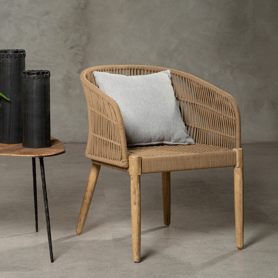 Wicker chair with a gray cushion on a gray floor and wall background