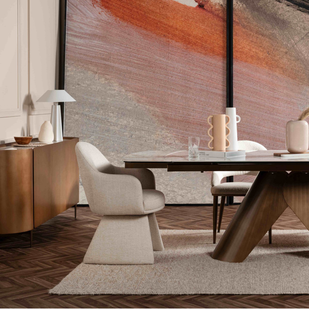 Modern dining room with a wooden table and chairs, abstract art on the wall.