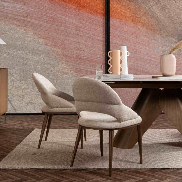 Modern dining room with a wooden table and chairs in front of a colorful abstract painting.