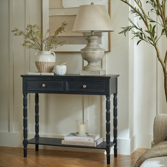 Console table with decorative items in a living room setting