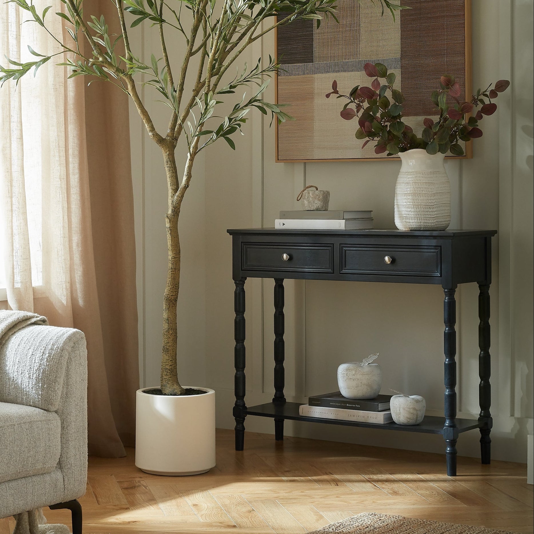 Living room with sofa, and black wood side table.
