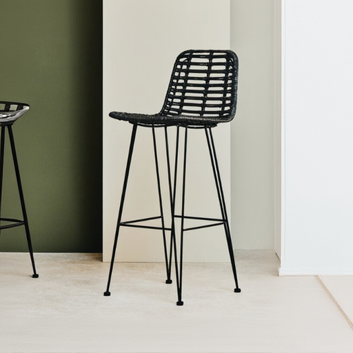 Black woven bar stool against a green wall
