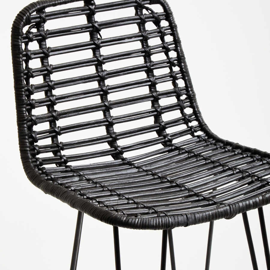 Black wicker chair with metal legs on a white background