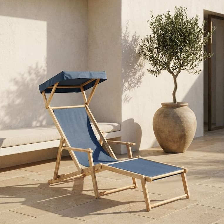 Blue deck chair with canopy on a stone patio next to a white wall and potted plant.