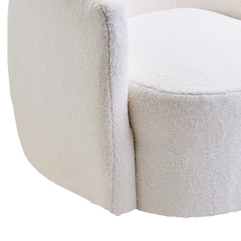 Round, plush ottoman with a textured surface on a white background