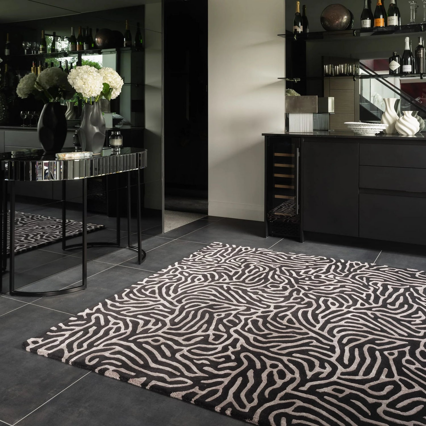 Patterned rug on a dark floor with a modern interior setting