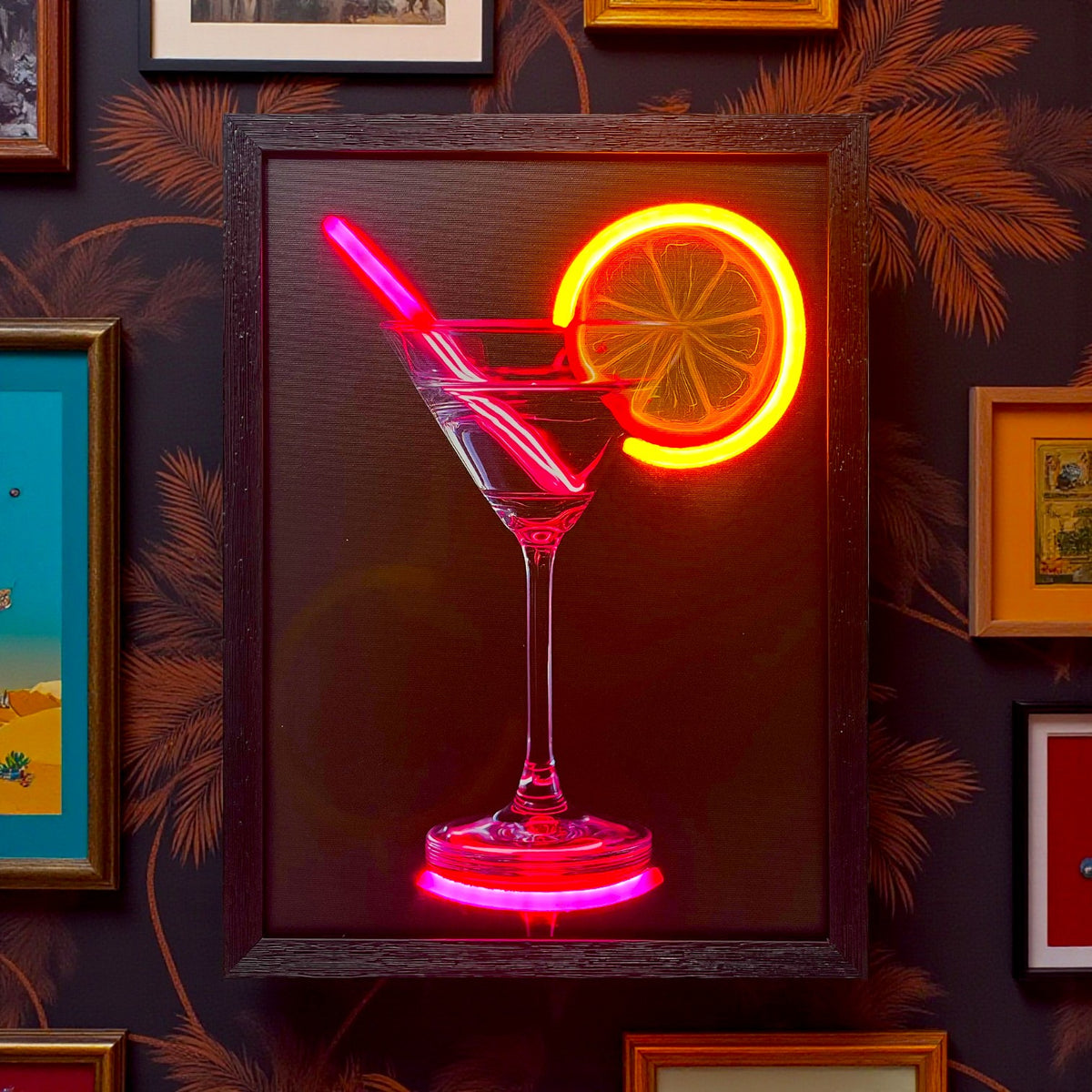 Neon sign of a cocktail glass with a slice of lemon on a dark wall with framed pictures.