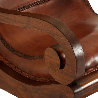 Close-up of a wooden armchair with intricate carvings on a white background