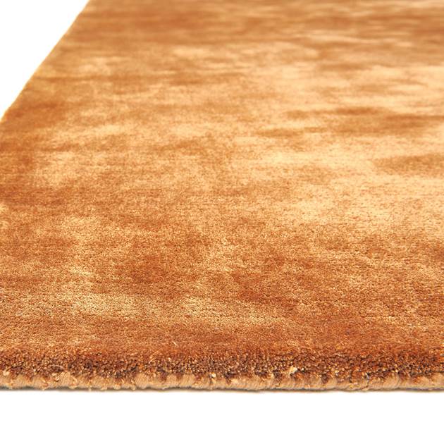 Close-up of a copper textured rug on a white background