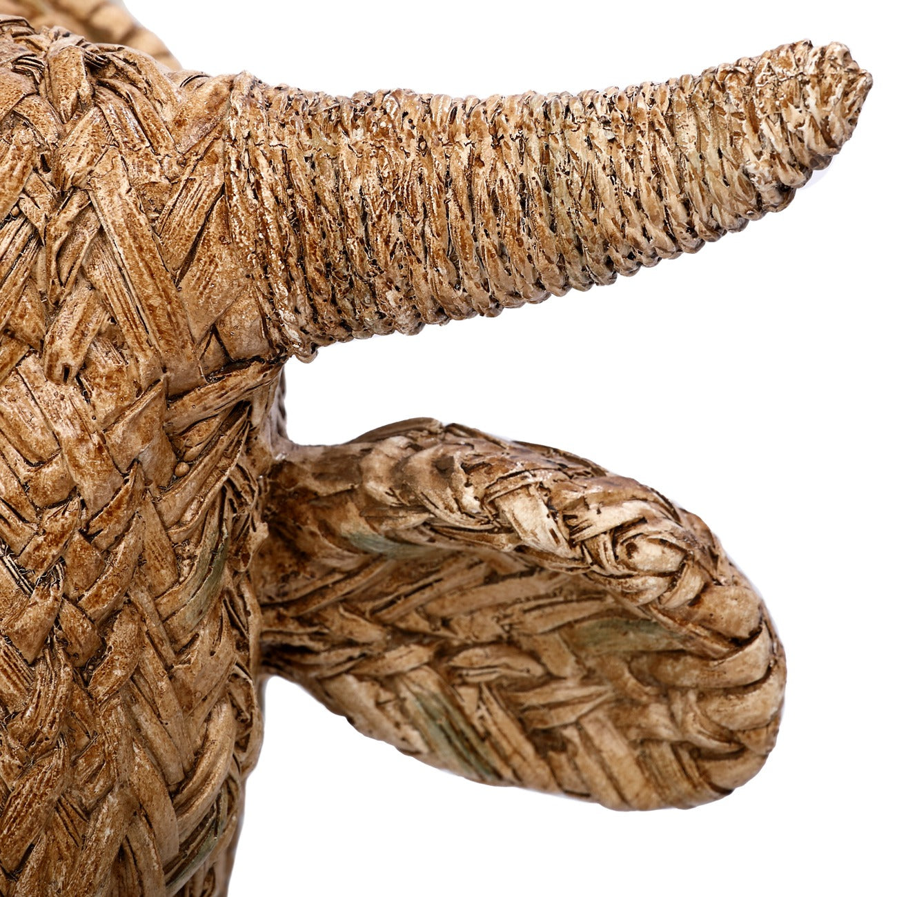 Close-up of a woven cow on a white background