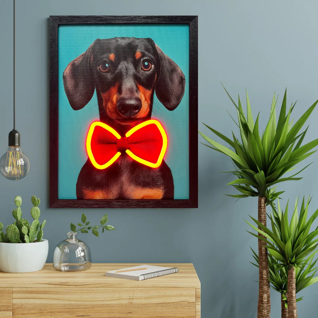 Framed artwork of a dog with a red bow tie on a teal wall above a wooden surface.