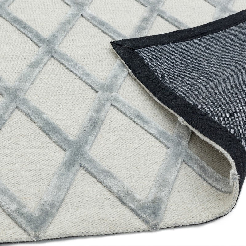 Close-up of a textured rug with geometric pattern and dark border