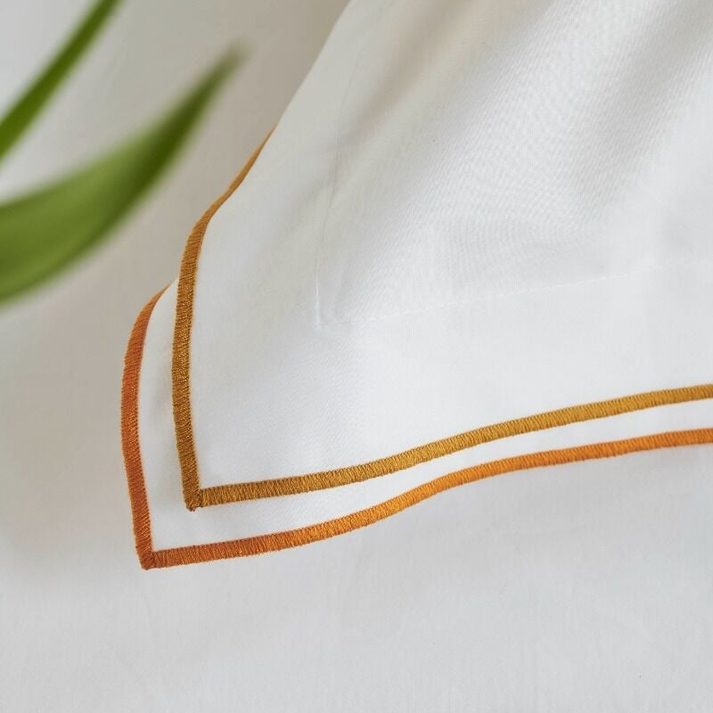 Close-up of a white fabric with orange trim on a light background