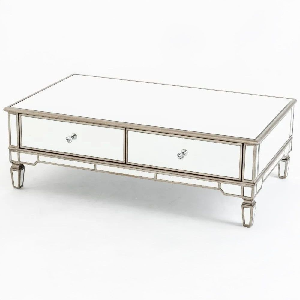 Decorative coffee table with mirrored surface and metallic frame on a white background