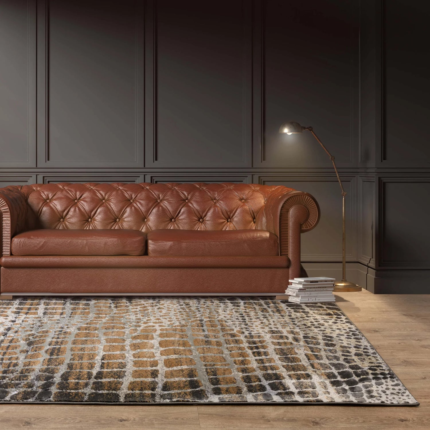 Brown leather sofa in a room with dark paneled walls and a giraffe spot patterned rug.
