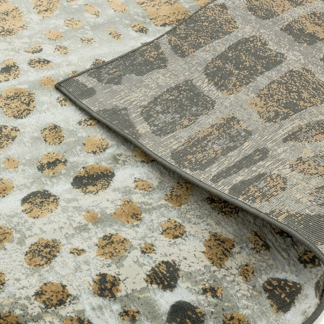 Close-up of a textured rug with geometric pattern on a neutral background