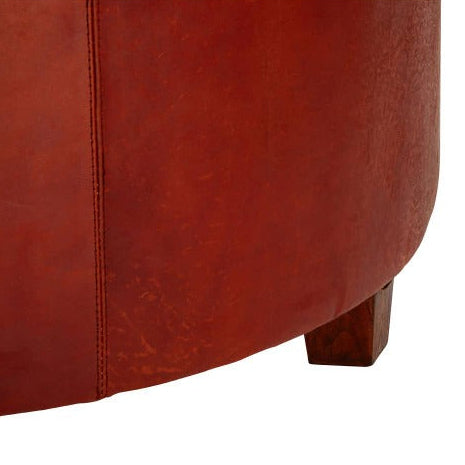 Close-up of a brown leather ottoman on a white background