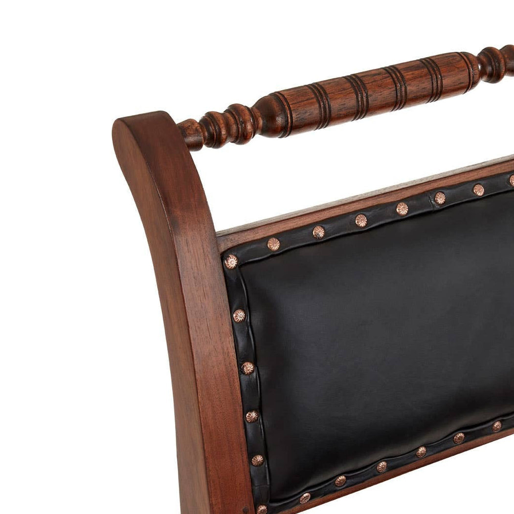 Wooden chair with black cushion and brass studs on a white background