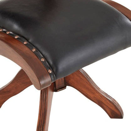 Wooden chair with a black leather seat on a white background