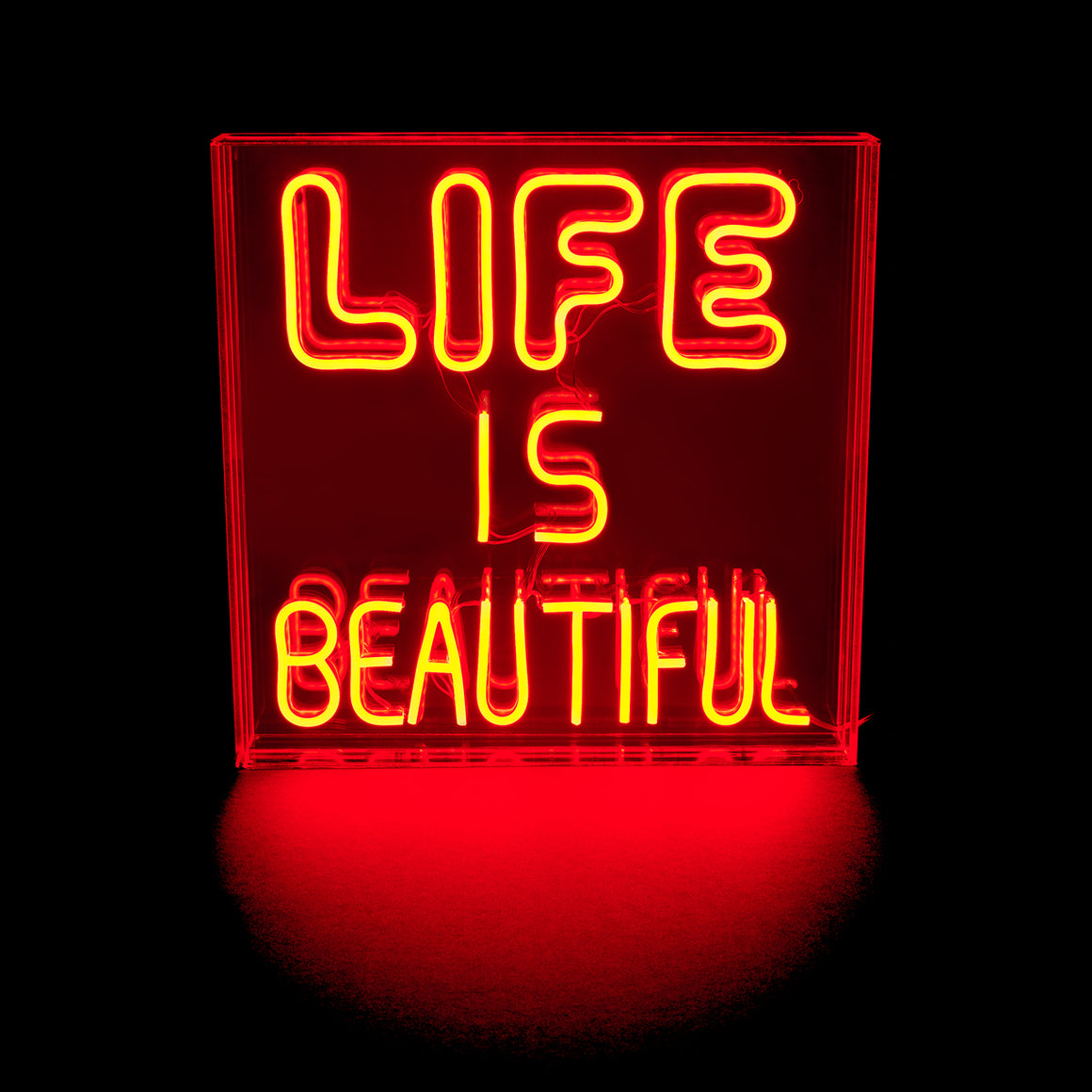 Neon sign with 'LIFE IS BEAUTIFUL' text on a black background