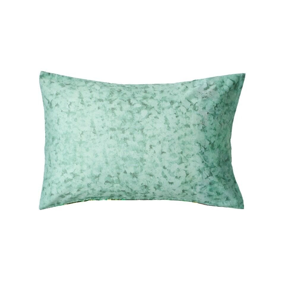 Green floral pillow on a white background