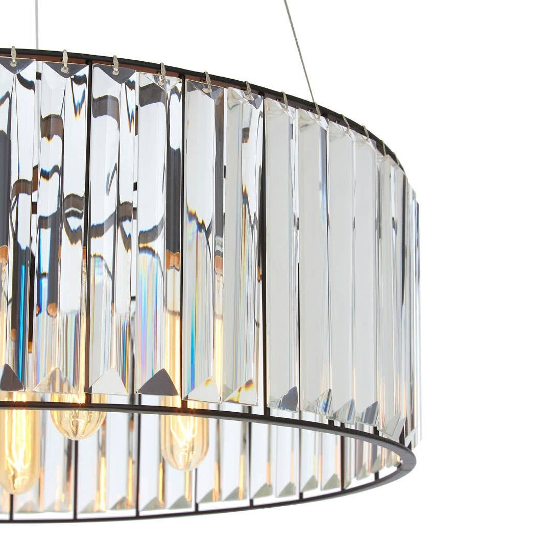 Chandelier with glass panels and visible bulbs on a white background