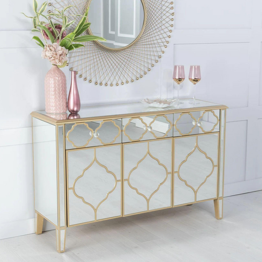 Decorative console table with gold geometric patterns on a white wall background