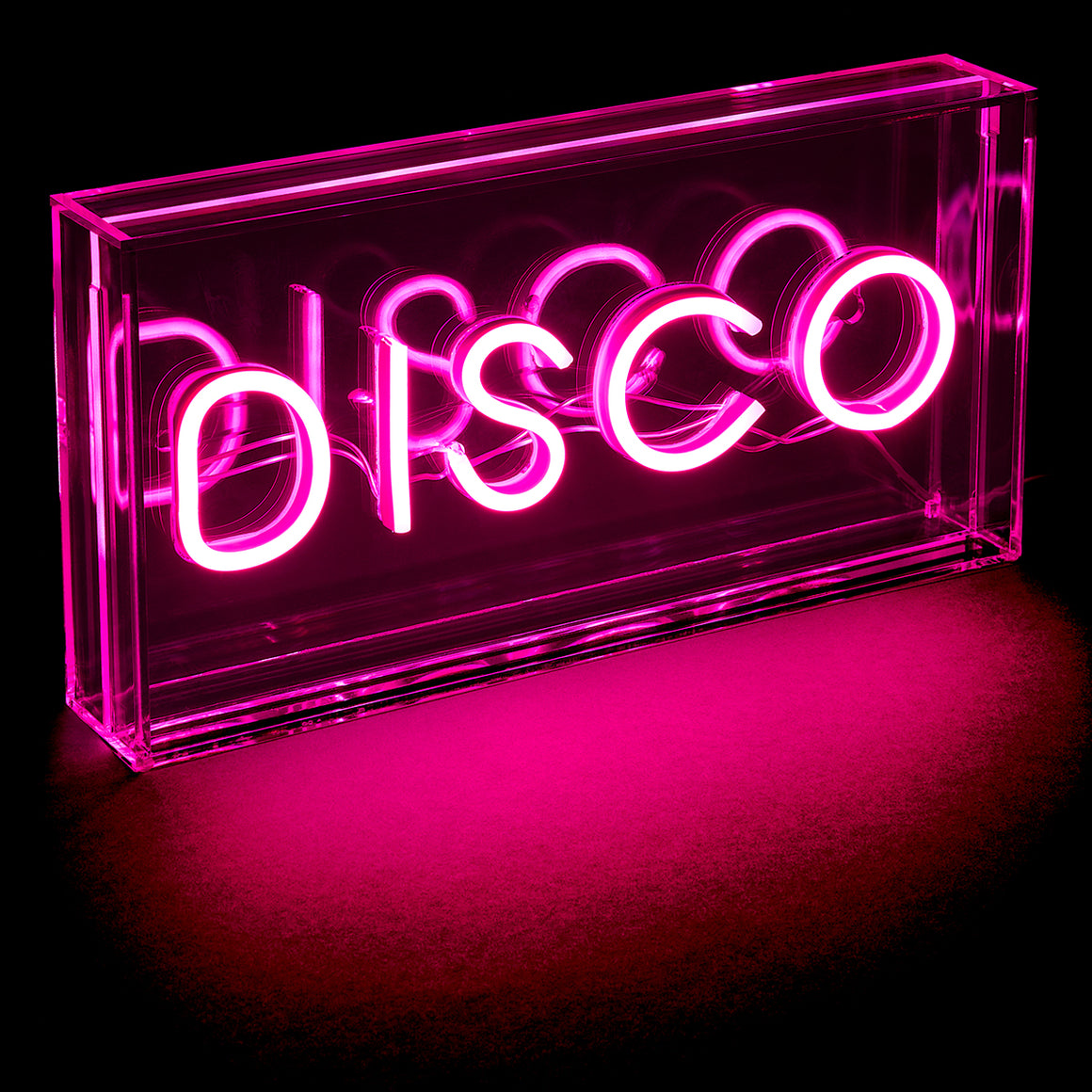Neon sign spelling 'DISCO' inside a transparent cassette tape box on a black background