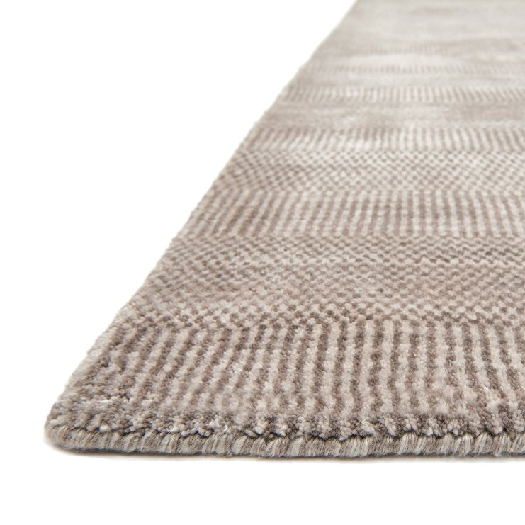 Textured beige rug on a white background