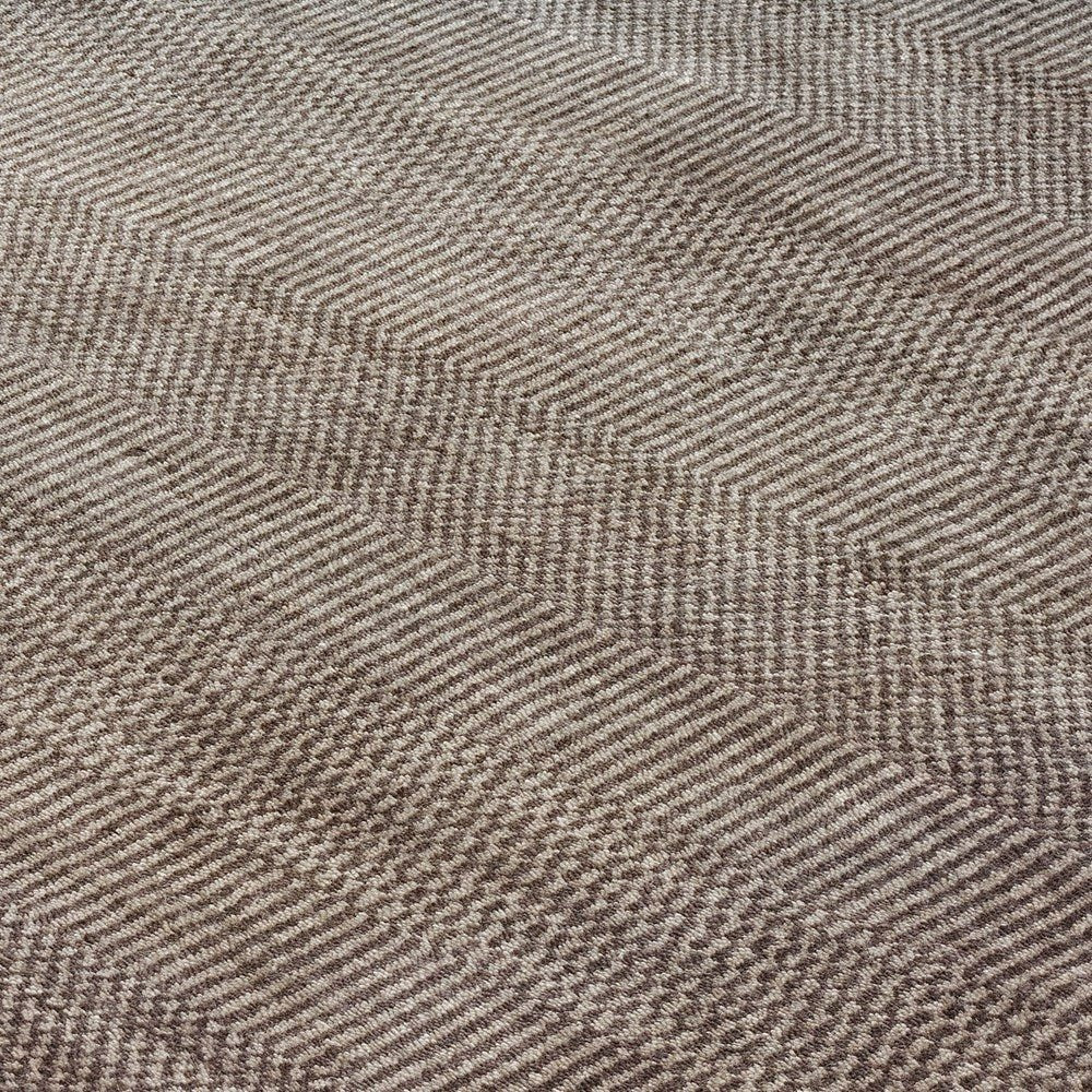 Close-up of a textured brown rug with a geometric pattern