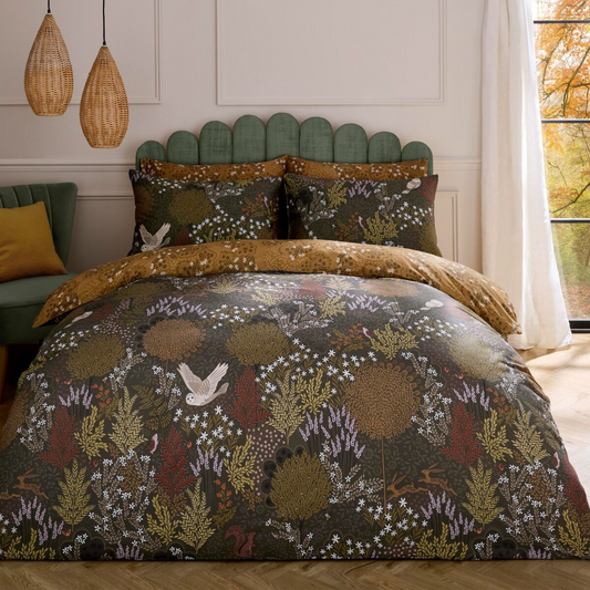 Bed with floral patterned duvet and pillows in a bedroom setting.