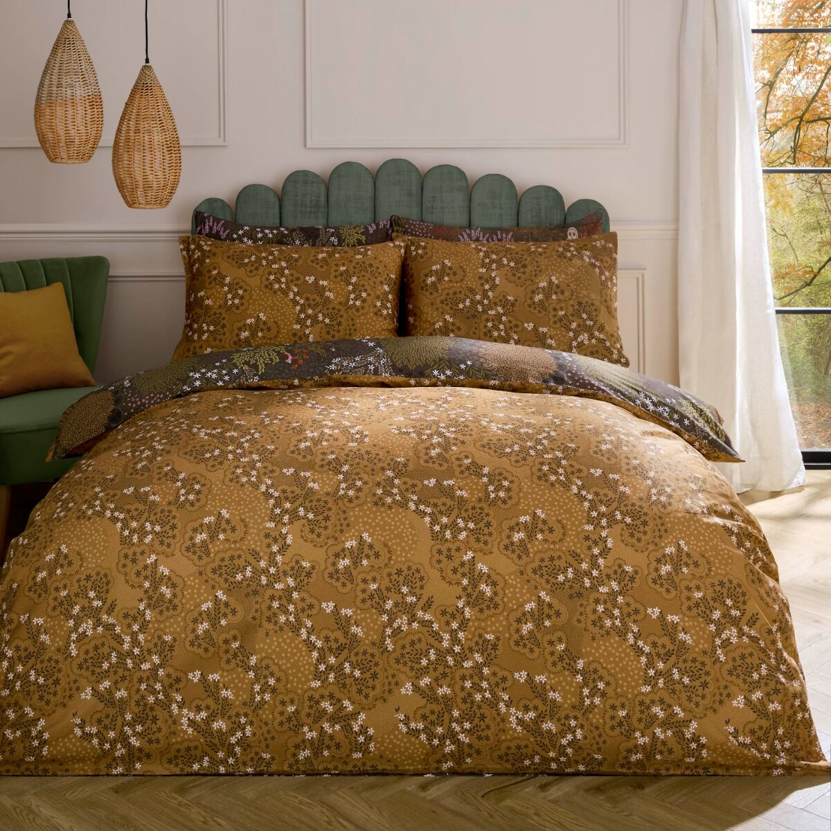 Bedroom with floral-patterned bedding and decorative pillows.