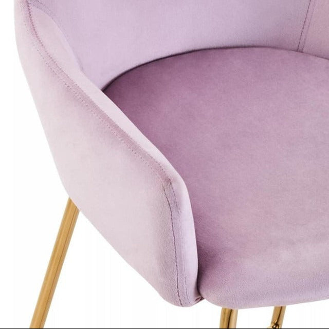 pink velvet chair with gold legs on a white background