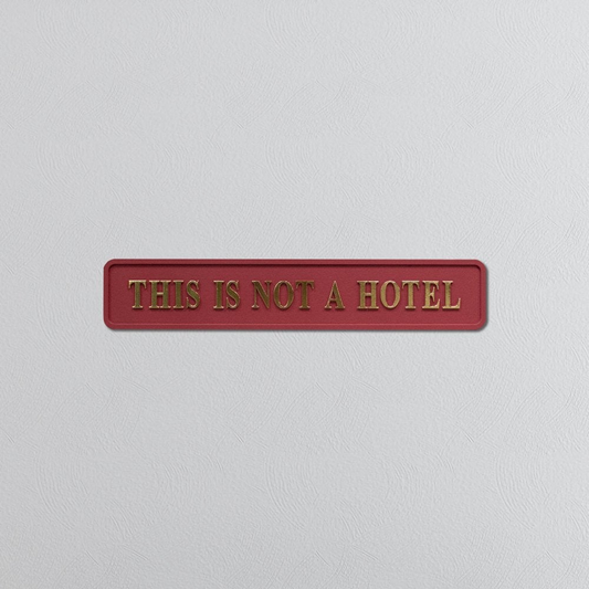 Red and Gold 'This Is Not A Hotel' Sign