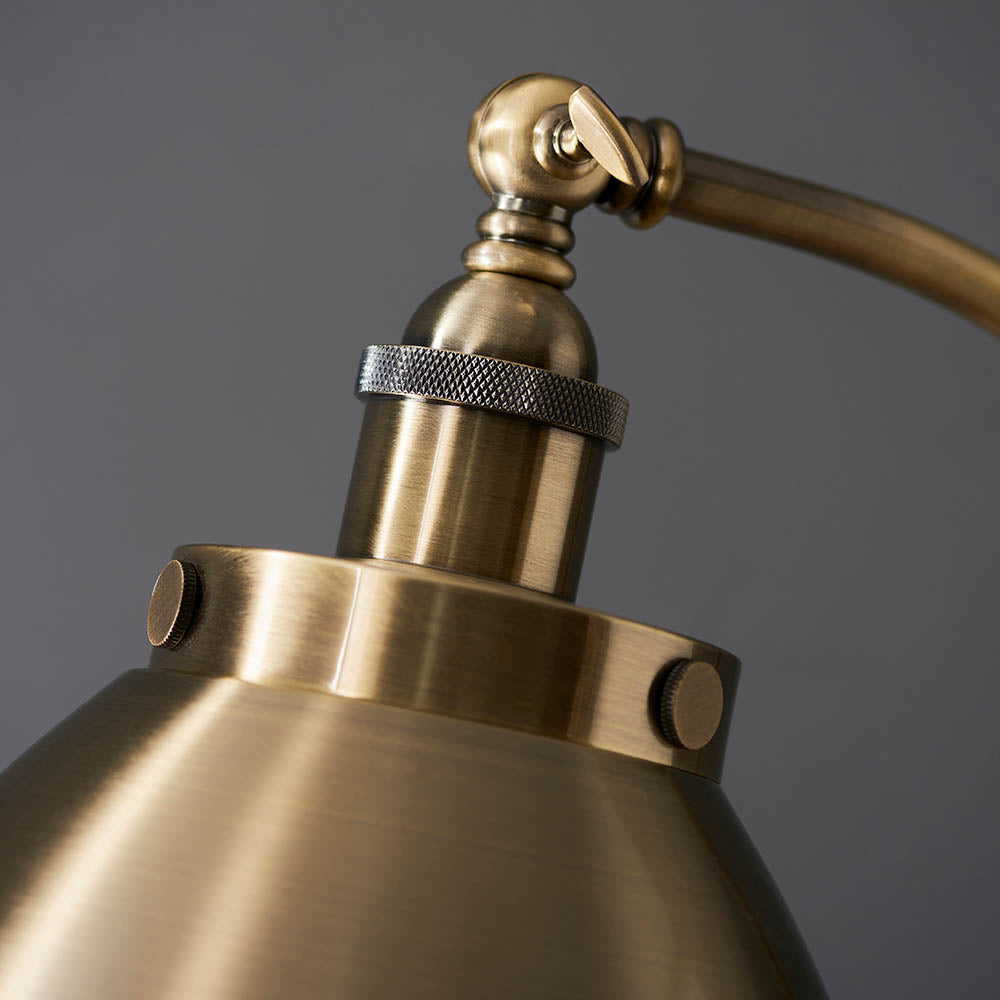 Close-up of a brass lamp with a dark gray background