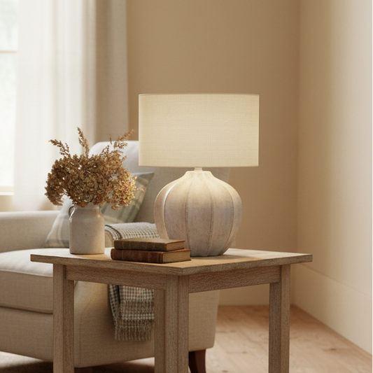 Cozy living room with beige armchair, wooden side table, and lamp.