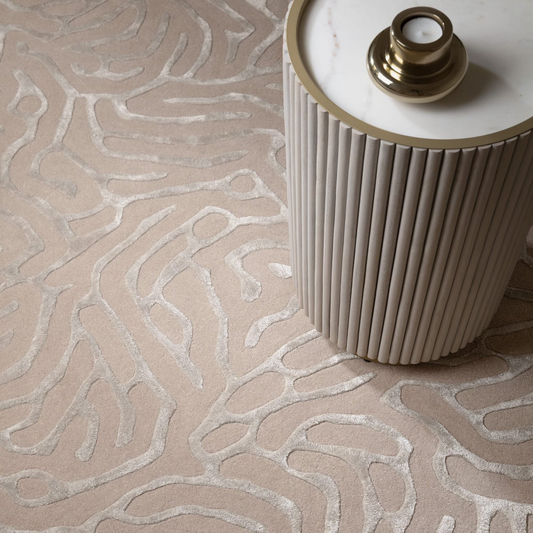 Decorative lamp on a textured rug with wavy pattern