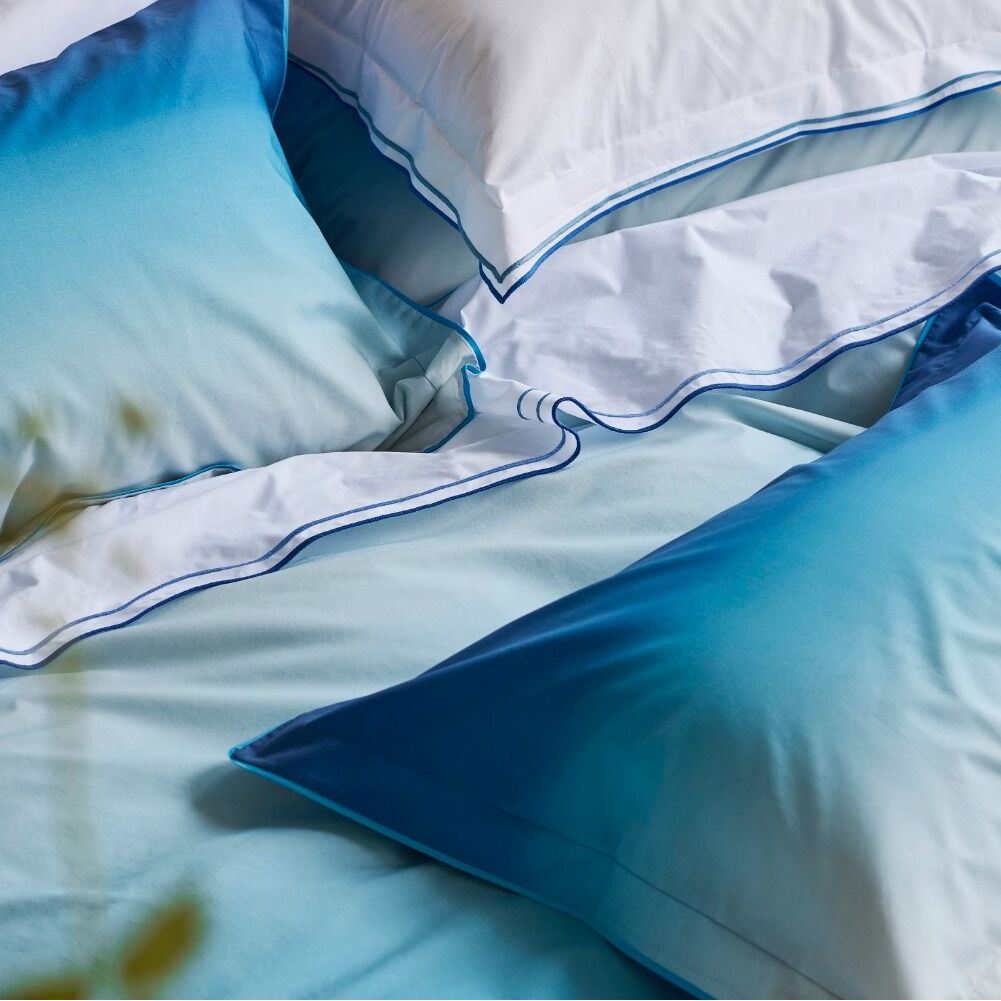 Close-up of blue and white bedding with a blurred background