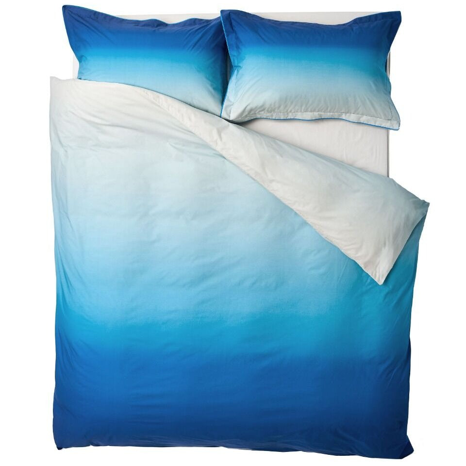 Blue and white gradient bedding set with pillows on a white background