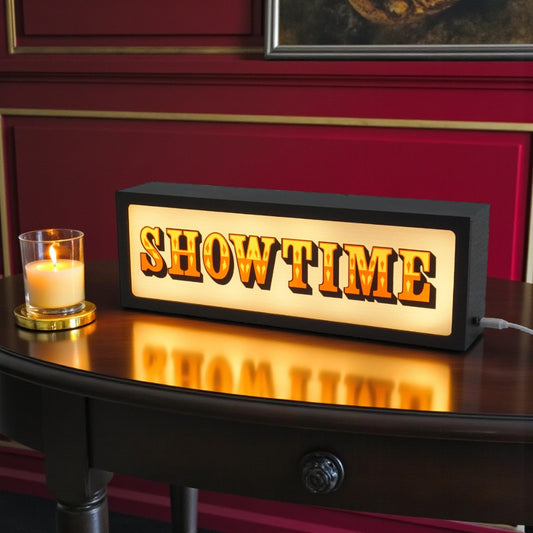 Decorative sign with 'SHOW TIME' text on a wooden surface with a candle in the background.