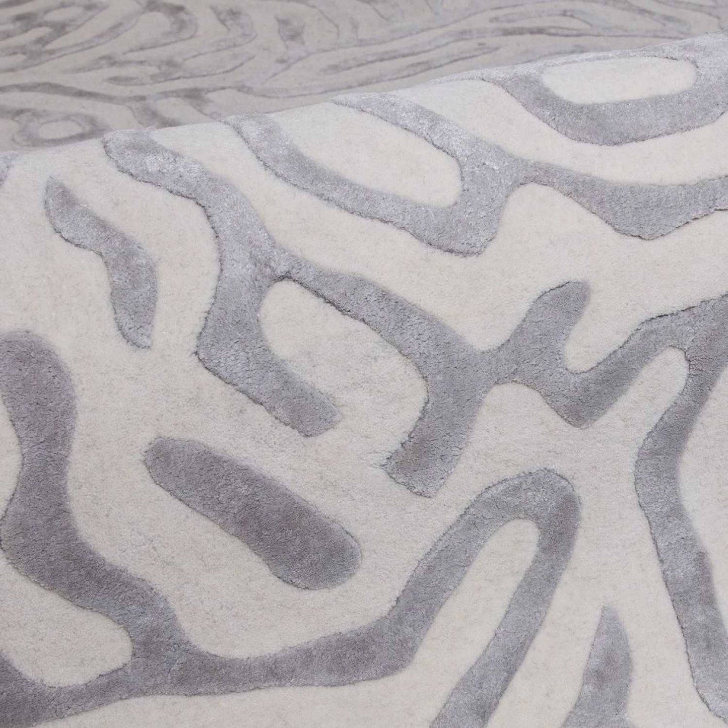 Close-up of a textured gray and white patterned rug