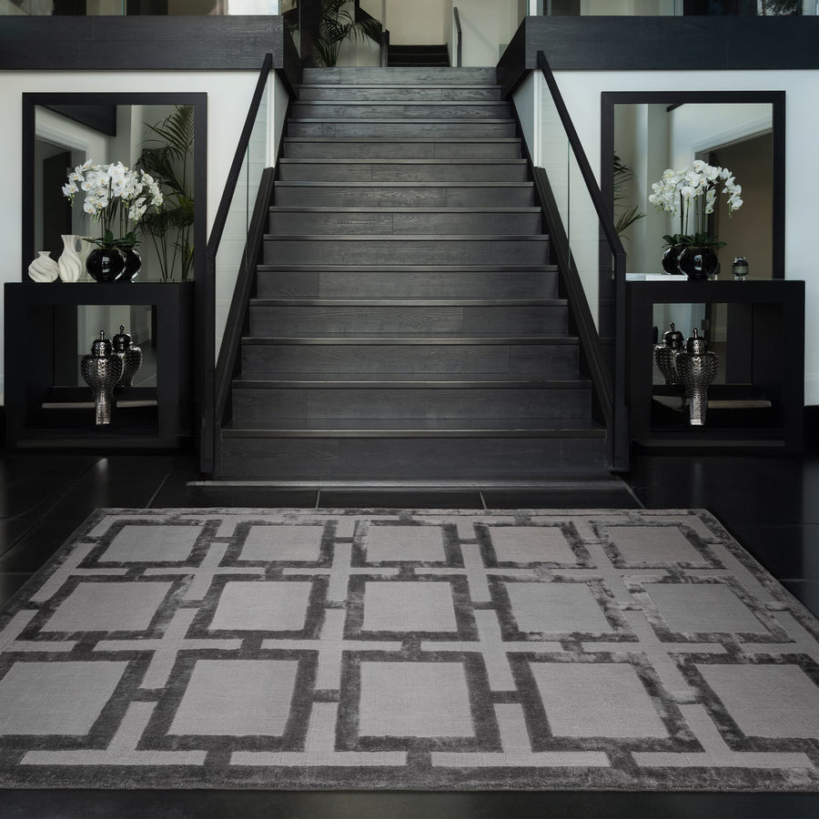 Staircase with a geometric patterned rug in a modern interior setting.