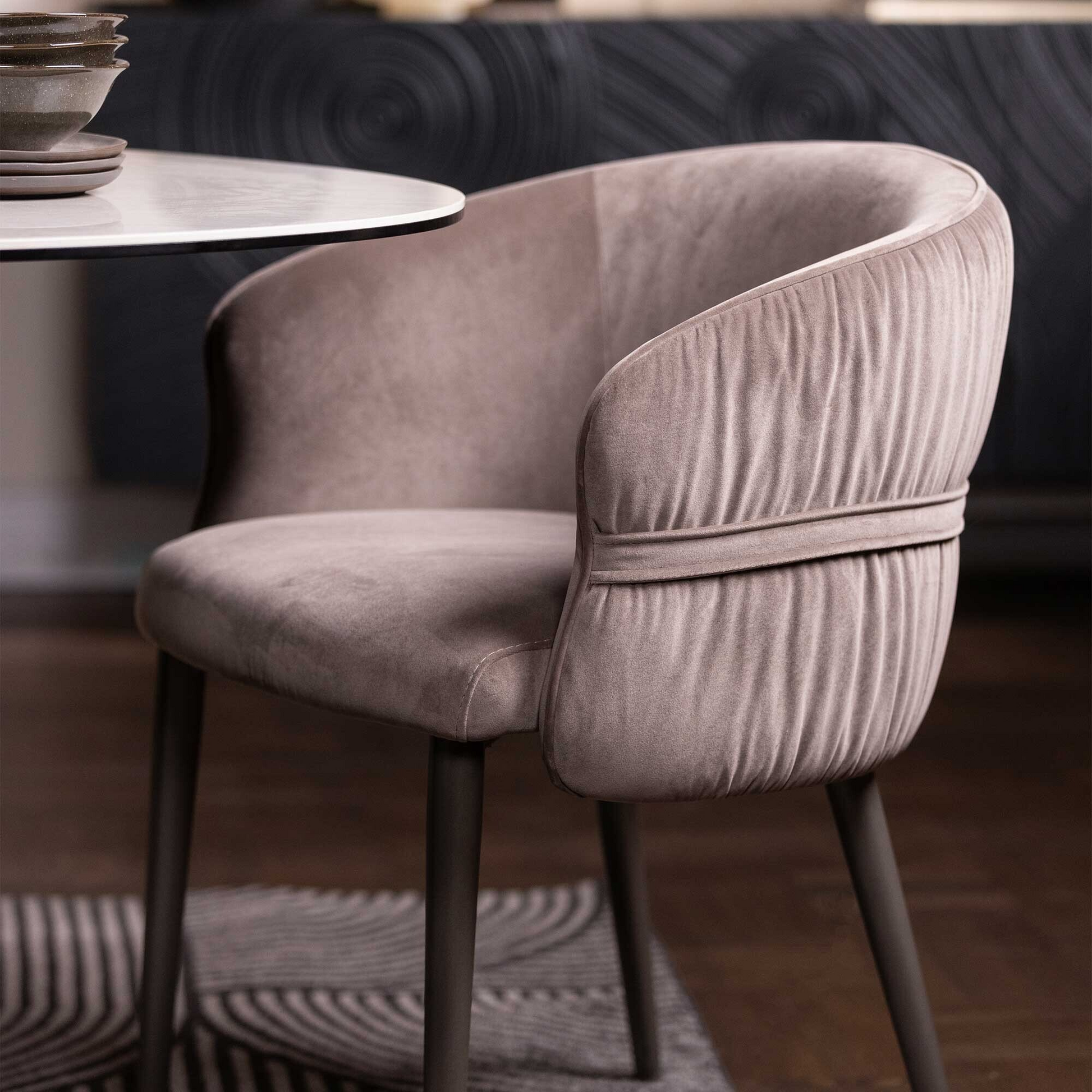 brown velvet chair in a blurred indoor setting