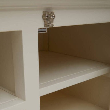 Close-up of a white cabinet with shelves and a door on a white background