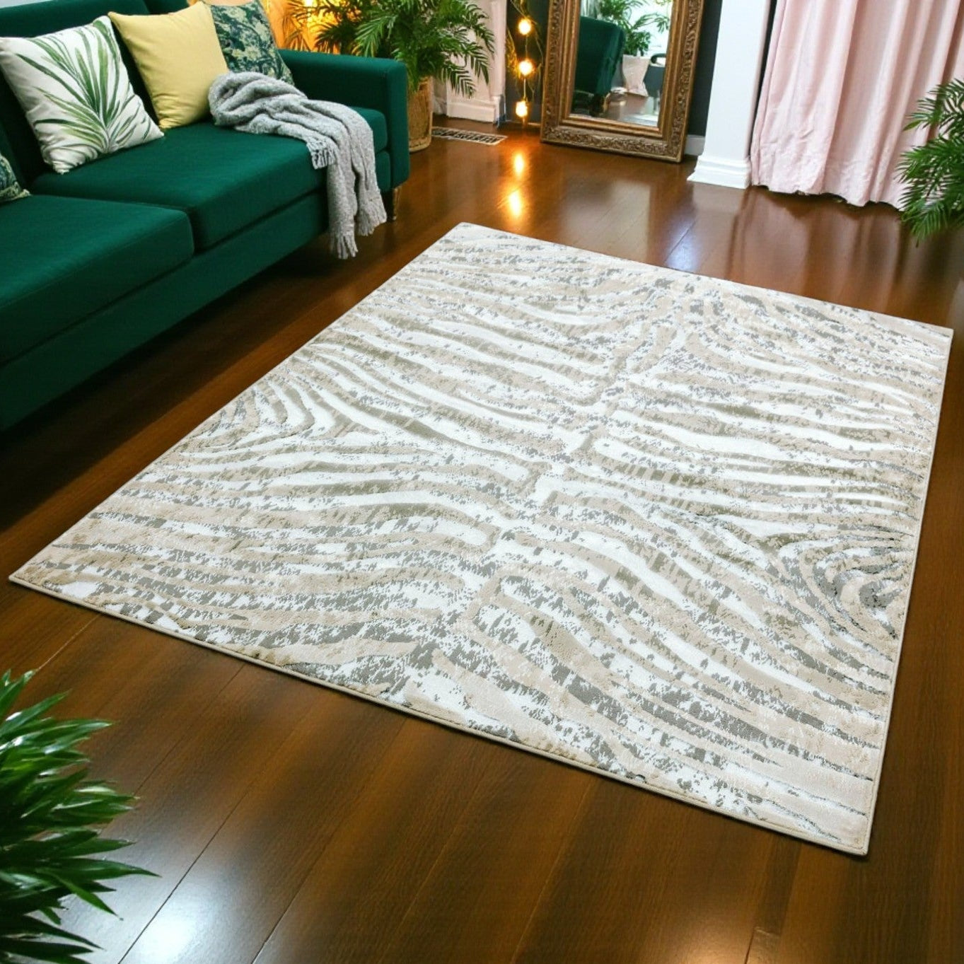 Patterned rug on a wooden floor in a living room setting with a green sofa and plants.